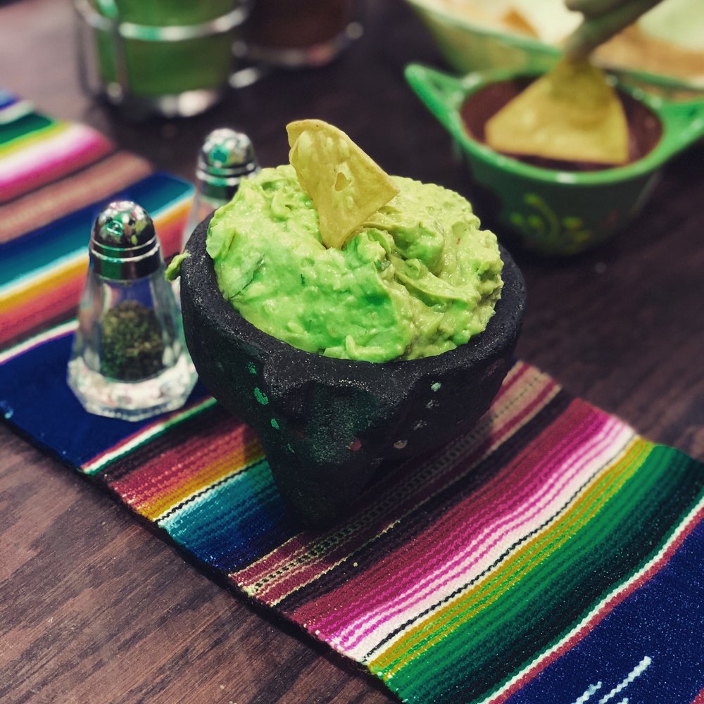 Fresh guacamole served in a molcajete